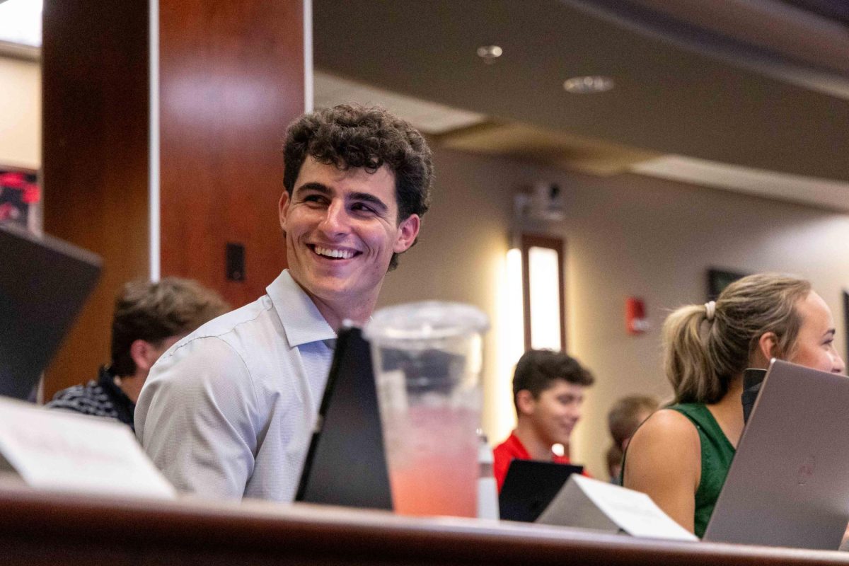 Chief Financial Officer Gabriel Jerdon laughs with the rest of the student senate during the weekly student senate meeting in the DSU senate chambers on Sept. 16, 2025.