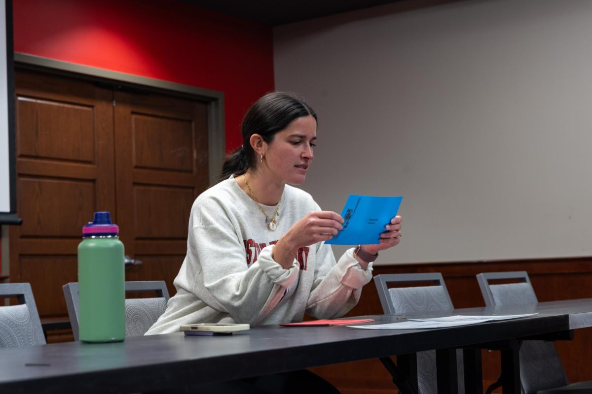 Abigail Farley, a 28-year old school psychologist for Warren County Schools, volunteered for the event through her husband Zach Farley, a WKU assistant professor of public health, on October 22nd, 2025. She is running the “Shelter” station of the event where students have to flip a coin to determine if there’s a “line” for the shelter their scenario took them to. She is reading off the card that determines where the students can go next in their scenario.
