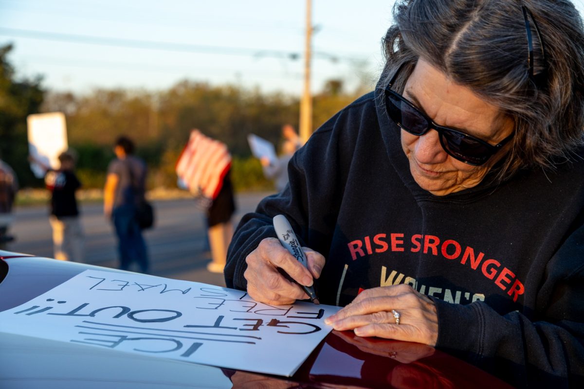 Denise Zielinski works on making signs during the impromptu protest outside of Bowling Green’s DHS headquarters on Wednesday, Nov. 5, 2025, in protest of the recent arrest of Ismael Cruz Sanchez by ICE.