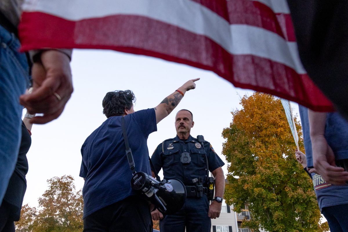 Congressional candidate Megan Wingfield speaks with Captain Mike Elliott of the BGPD after ICE agents called to have protestors removed from the building’s parking lot on Wednesday, Nov. 5, 2025, during a protest of the recent arrest of Ismael Cruz Sanchez.
