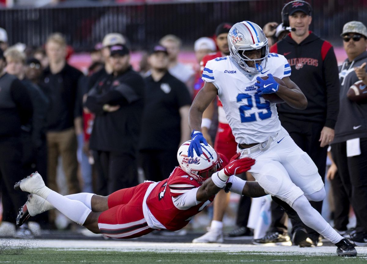 Western Kentucky University Hilltoppers linebacker Jaylen Wester (21) attempts to tackle Middle Tennessee running back DJ Taylor (29) during WKU’s game against MTSU on Saturday, Nov. 15, 2025, in Houchens-Smith Stadium.