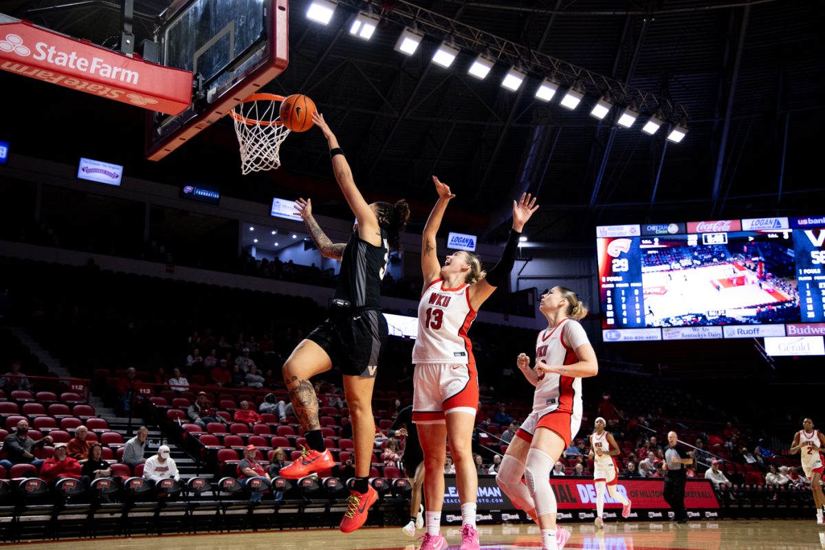 Western Kentucky University forward Tatum Boettjer (13) attempts to block a shot by University of Vanderbilt forward Sacha Washington (35) during WKU’s game against the Vanderbilt University Commodores in Diddle Arena on Wednesday, Nov. 19, 2025.