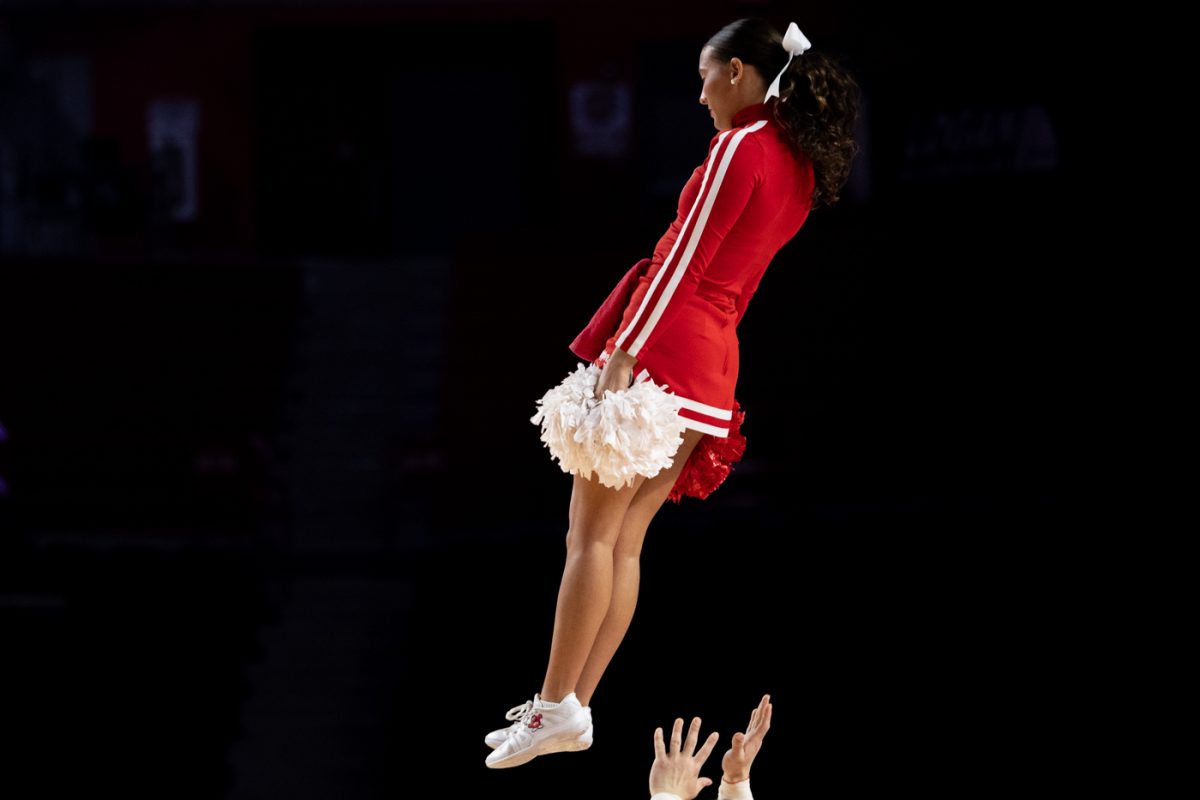 A member of the Western Kentucky University cheer squad falls through the air as they perform a halftime stunt during WKU’s game against the Vanderbilt University Commodores in Diddle Arena on Wednesday, Nov. 19, 2025.