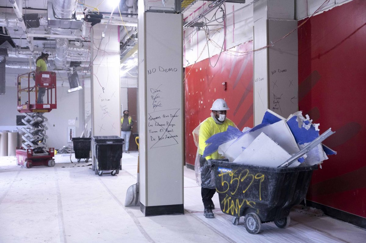 Construction workers tear down the celling in the main lobby in Regents Hall on Friday, Nov. 21, 2025.