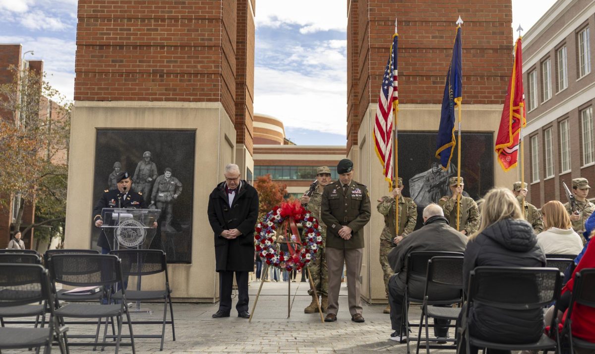 WKU president Timothy Caboni and Lt. Col. David Schnaak bow their heads while Major Chase Attwood speaks at the Veterans Day ceremony held by WKU ROTC at Guthrie Tower on Tuesday, Nov. 11, 2025.