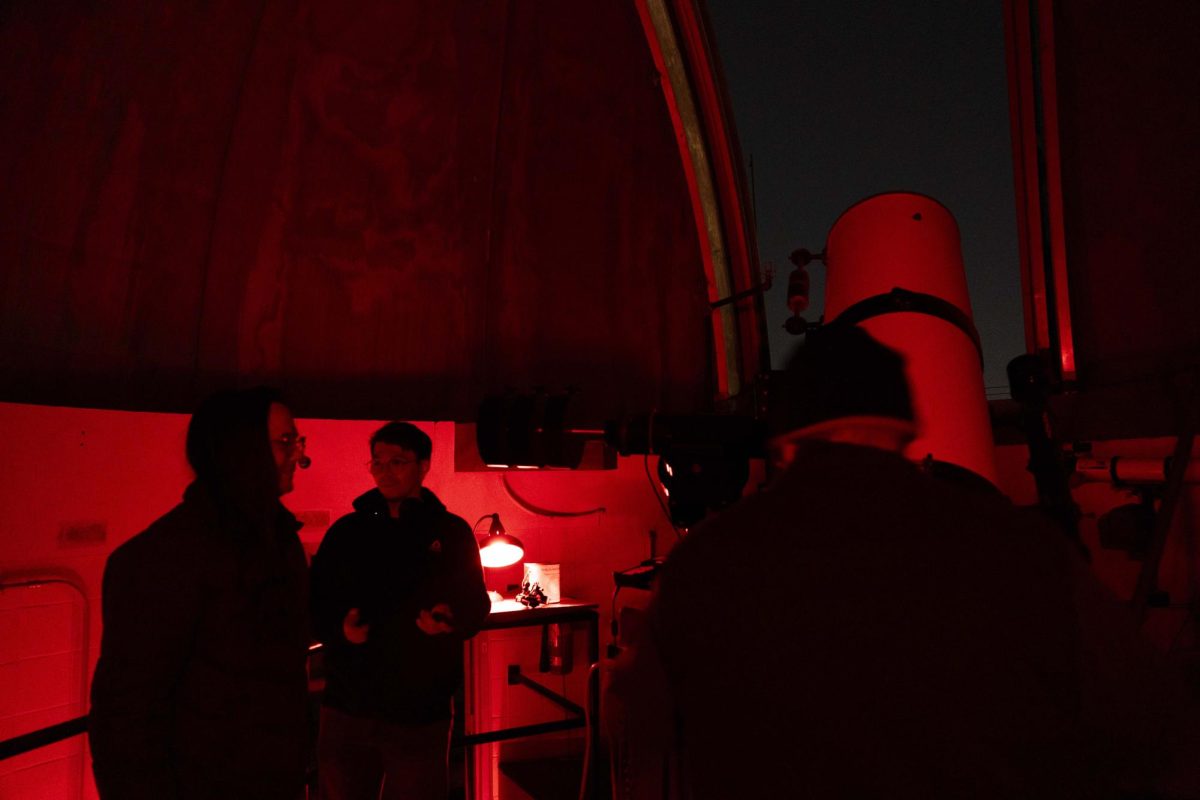 Maxx Haehn and Chris Barnes chat while people observe the sky at Kelly Thompson Hall’s rooftop observatory on Tuesday, Nov. 11, 2025.