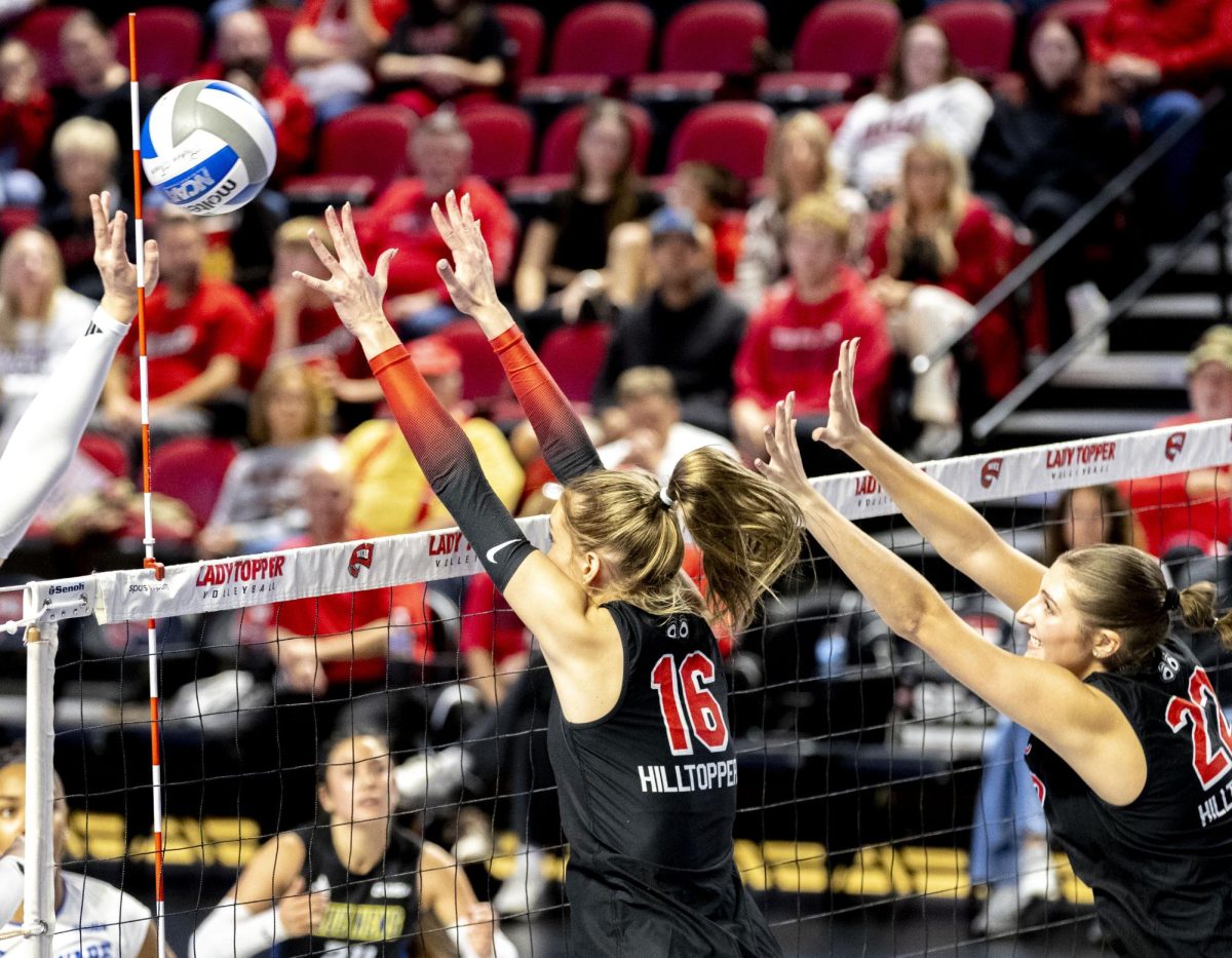 Western Kentucky University outside hitter Sonja Laaksonen (16) and outside hitter Faith Young (22) block a spike during WKU’s game against Delaware in E.A. Diddle Arena on Saturday, Nov. 8, 2025. 