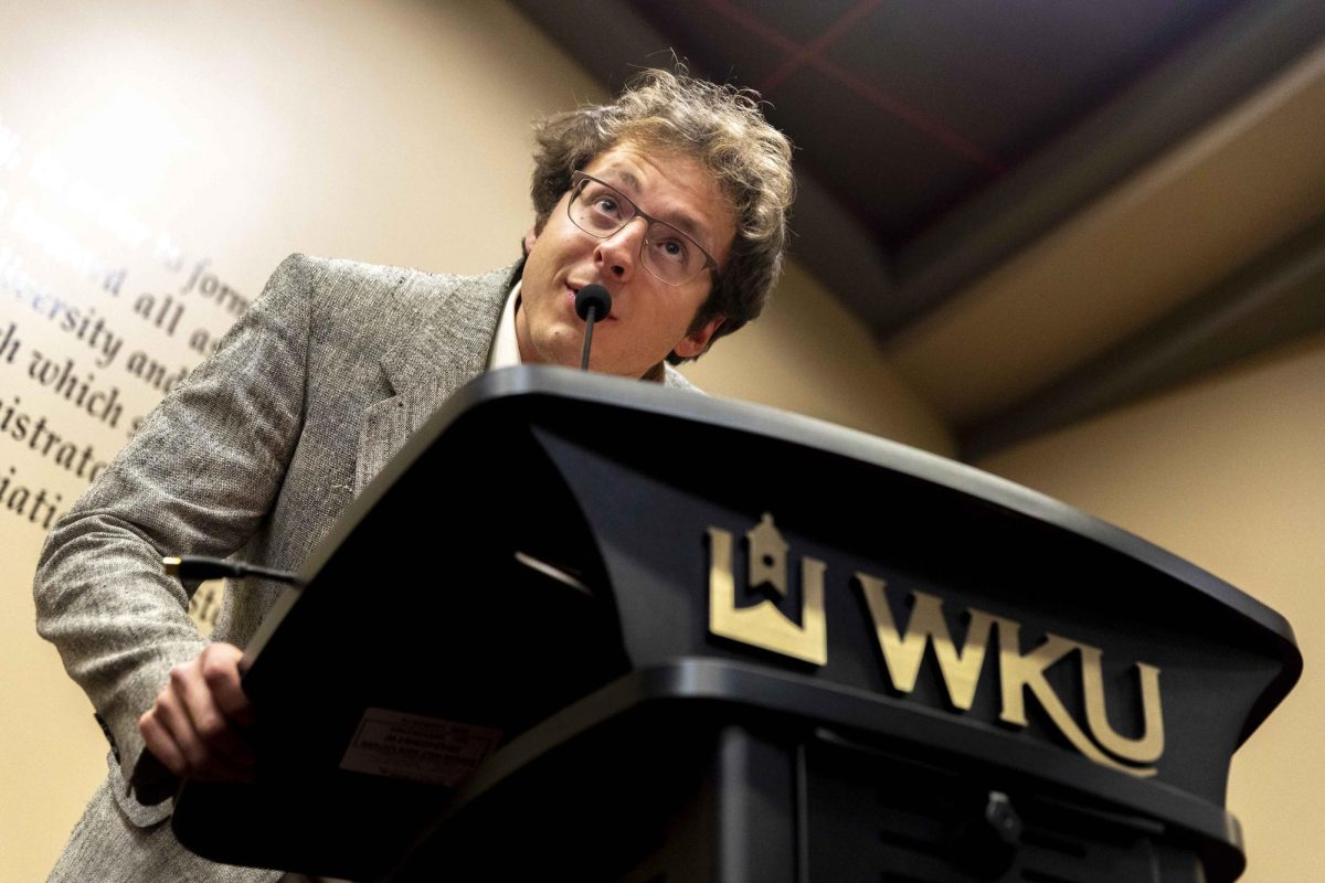 Chief Communications Officer Preston Jenkins leans into the mic while giving his report during the weekly SGA meeting on Tuesday, Nov. 18, 2025 in the Senate Chambers.