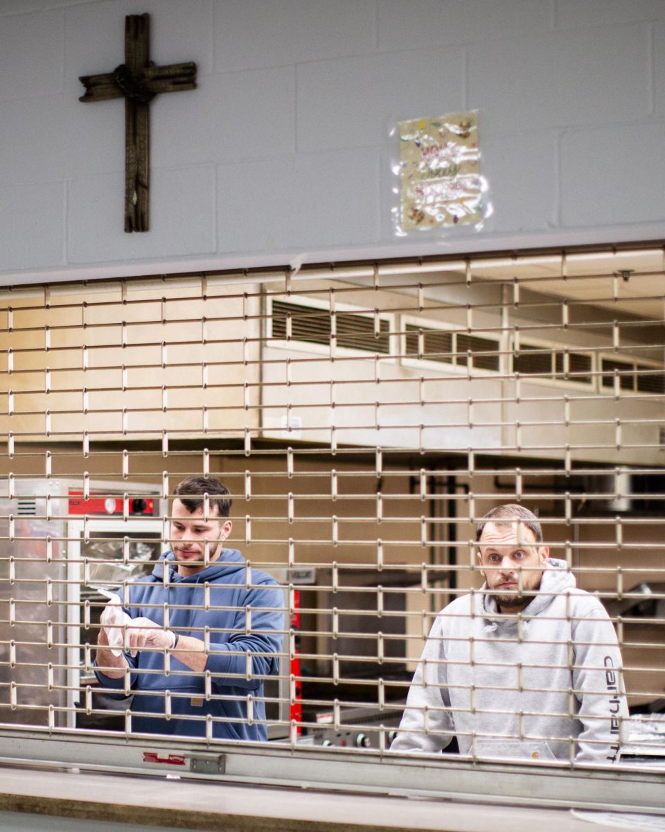Austin McGrath, left, and Elliott Geer, outpatient volunteers from the Men’s Addiction Recovery Center, prepare food inside the kitchen before homeless guest line up at the Salvation Army’s warming center on W. Main Ave in Bowling Green, Ky. on Saturday, Jan. 24, 2026 during intense winter weather. 