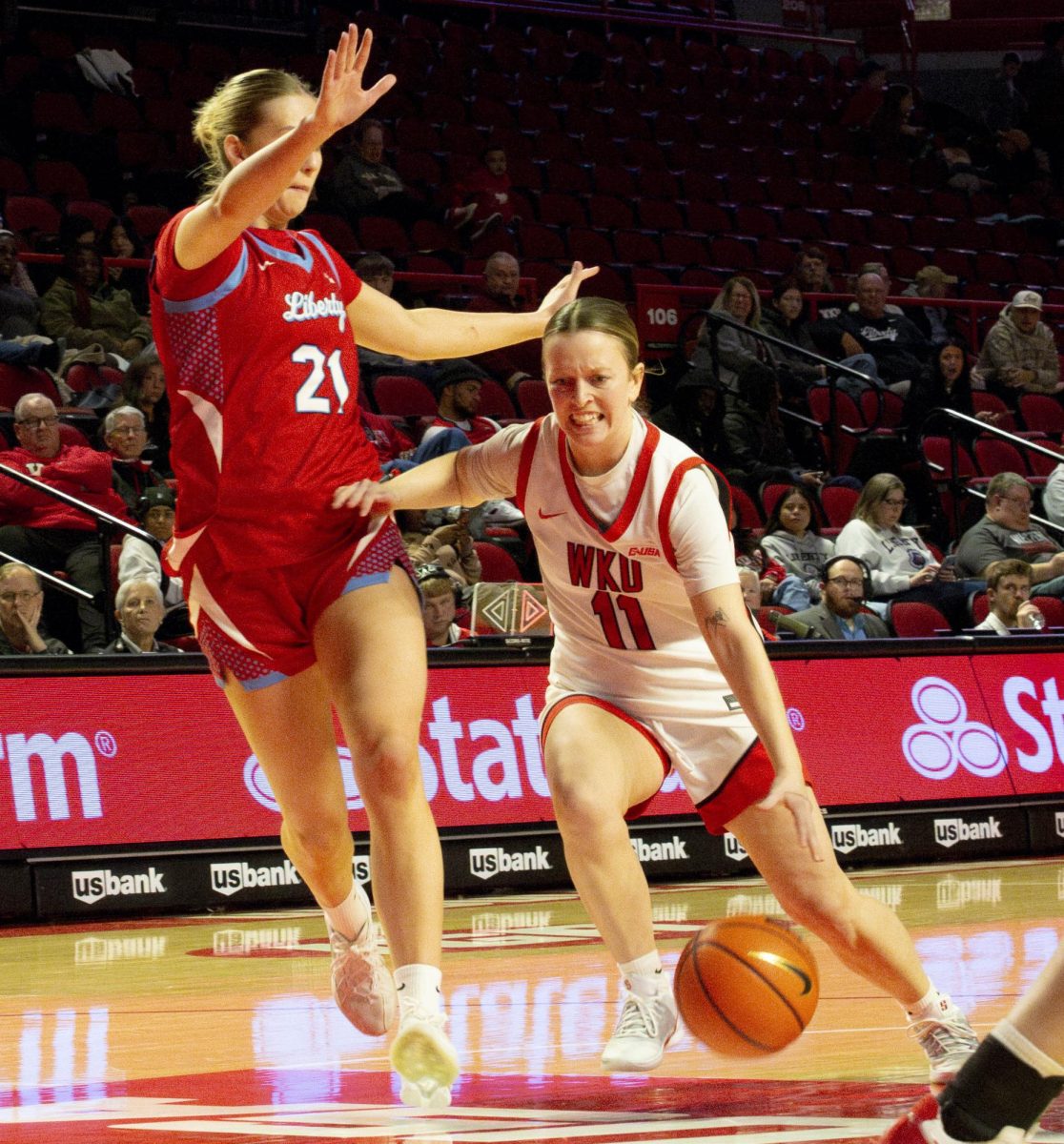 Western Kentucky University Hilltoppers guard Trinity Rowe (11) rushes passes Liberty University forward Elisabeth Aegisdottir on Thursday, Jan. 22, 2026 during WKU’s game against the Liberty Flames. The Hilltoppers lost 53-55, which is their 3rd loss in a row. 