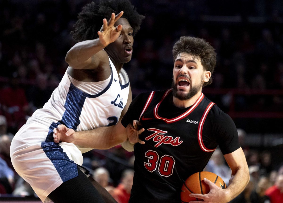 Western Kentucky Hilltoppers Guard Teagan Moore (30) pushes past Liberty University Flames Forward Ryan Jones Jr. (21) to make a play on the hoop on Wednesday, Jan. 21, 2026 during WKU’s game against The Liberty Flames.