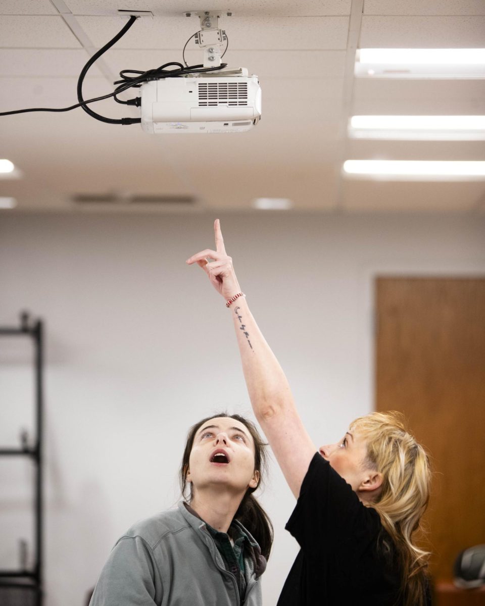 Lead organizers Al Sack, left, and Ayla Newton, right, work on a technical difficulty with the projector before an interest meeting held by the Bowling Green Community Defense organization at Lisa Rice Library in Bowling Green, Ky. on Saturday, Jan. 31, 2026. 