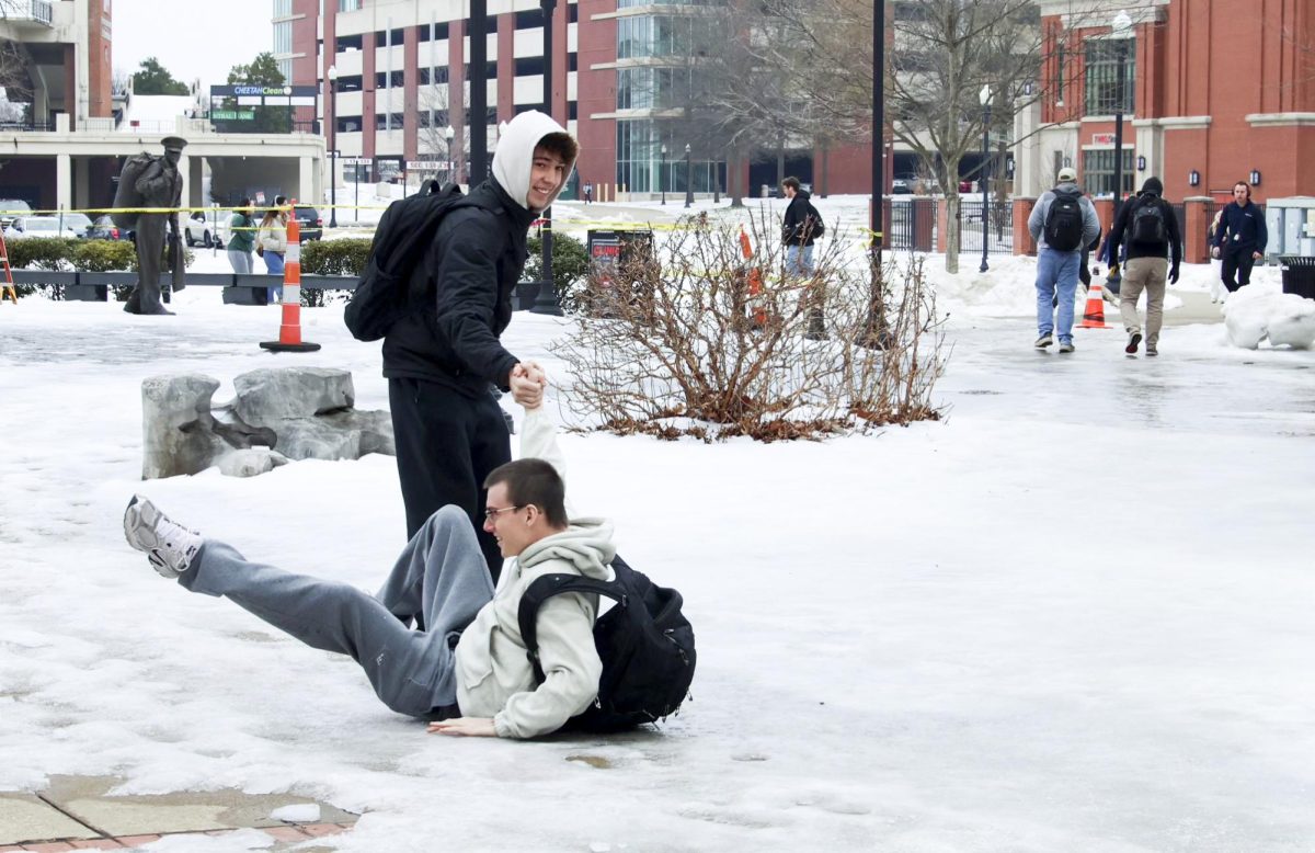 Students slip and slide on a patch of ice near Guthrie Tower on Thursday, Feb. 5, 2026. Many of WKU's stairs and pathways remain unusable as freezing temperatures remain. 