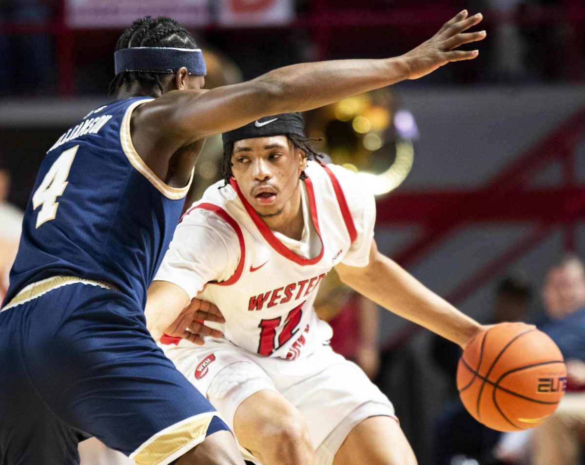 Western guard Armelo Boone (12) looks for a way around the FIU defense in a game on Saturday, Feb. 7, 2026 in E.A. Diddle Arena. Western won the match 80-70.