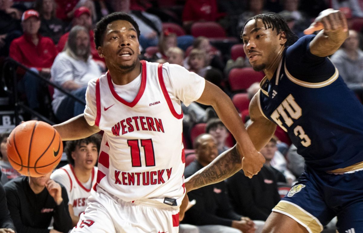 Western guard Terrion Murdix (11) drives past Florida International University guard Corey Stephenson (3) during a game against FIU on Saturday, Feb. 7, 2026. Murdix ended the game with six points.