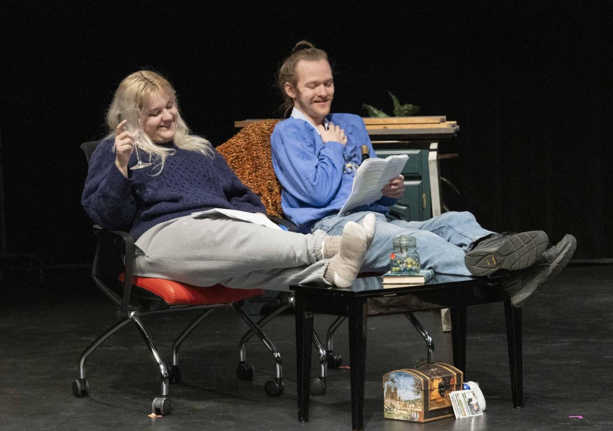 Junior Musical Theatre major Ireland Wolfe (left) and Freshman Theatre major Emory Heckman (right) laugh and smile as they share some wine during Plays in a Day produced by the WKU Student Chapter of Alpha Psi Omega at the Lab Theatre in Gordon Wilson Hall Sunday, Feb. 8, 2026. 