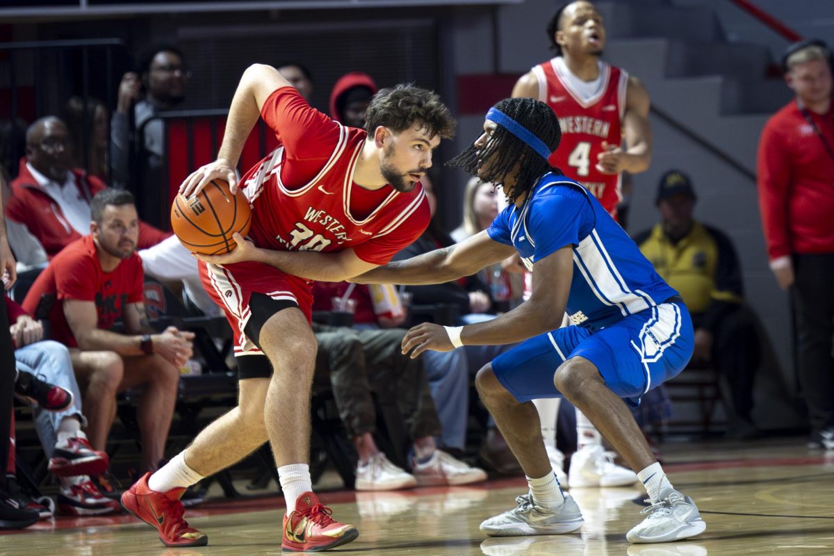 Western Kentucky University Hilltoppers guard Teagan Moore (30) attempted to pass the ball, blocking the ball from Middle Tennessee State University’s guard Tre Green on Saturday, Feb. 14, 2026. 