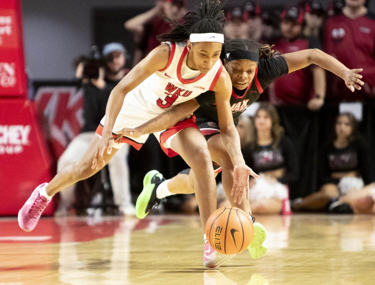 Western Kentucky University guard Tia Shelling (3) tips the ball away from Jax State’s Adriana Jones (23) during WKU’s Valentine’s Day game against Jacksonville State in E.A. Diddle Arena on Saturday, Feb. 14, 2026. 