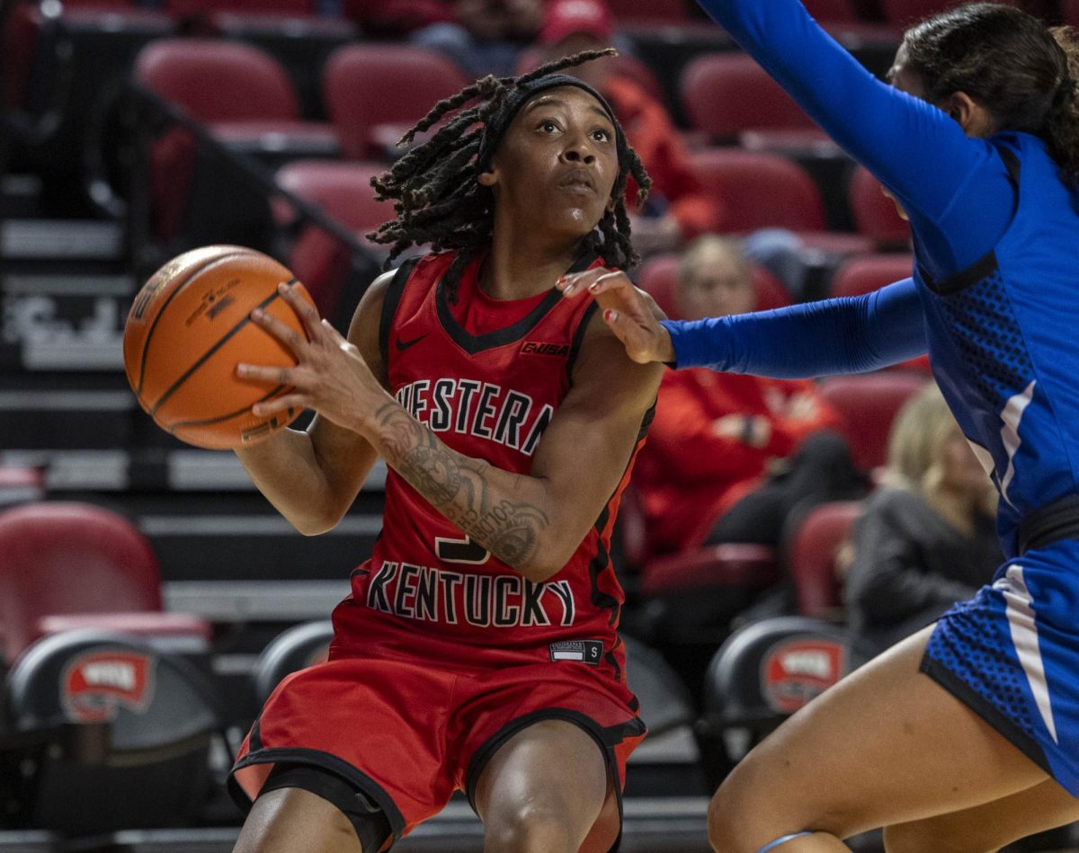 Western Kentucky University’s guard Tia Shelling (3) attempts to make a shot while Middle Tennessee State University guard Alayna Contreras (3) blocks during WKU’s game against MTSU in E.A. Diddle arena on Saturday, Feb. 21, 2026. 