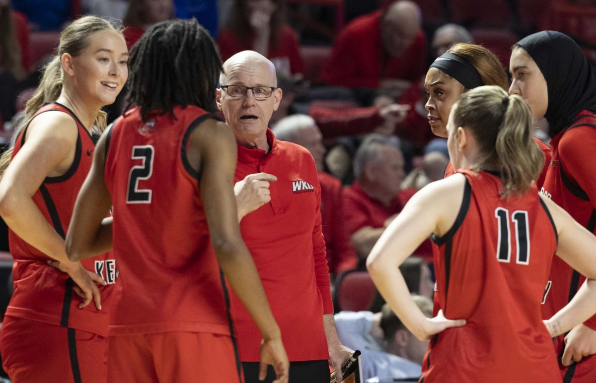 Western Kentucky University head coach Greg Collins speaks to his players during a quick timeout in the second half during WKU’s game against MTSU in E.A. Diddle arena on Saturday, Feb. 21, 2026. 
