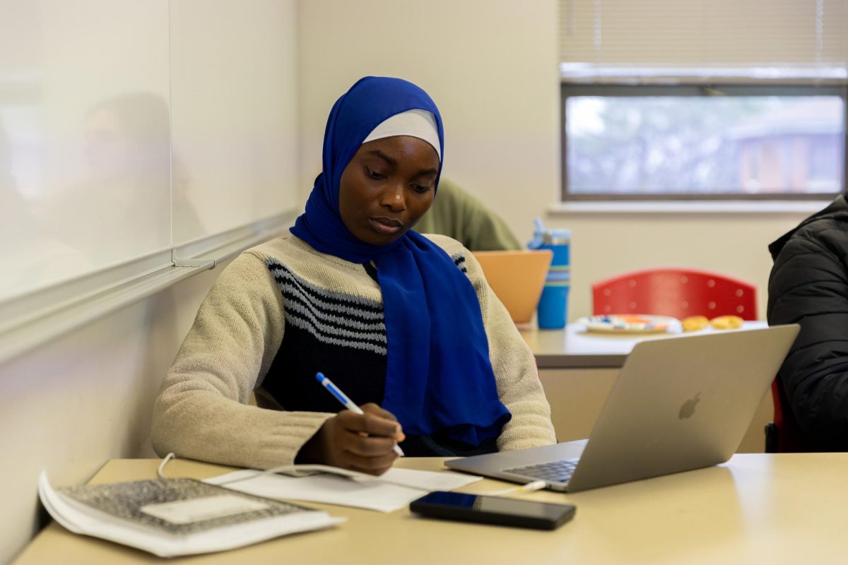Sukurat Kofoworola takes notes during the AMS Chapter Talk on Lie algebras featuring speaker Goran Omerdic at College High Hall on Wednesday, Feb. 25, 2026.