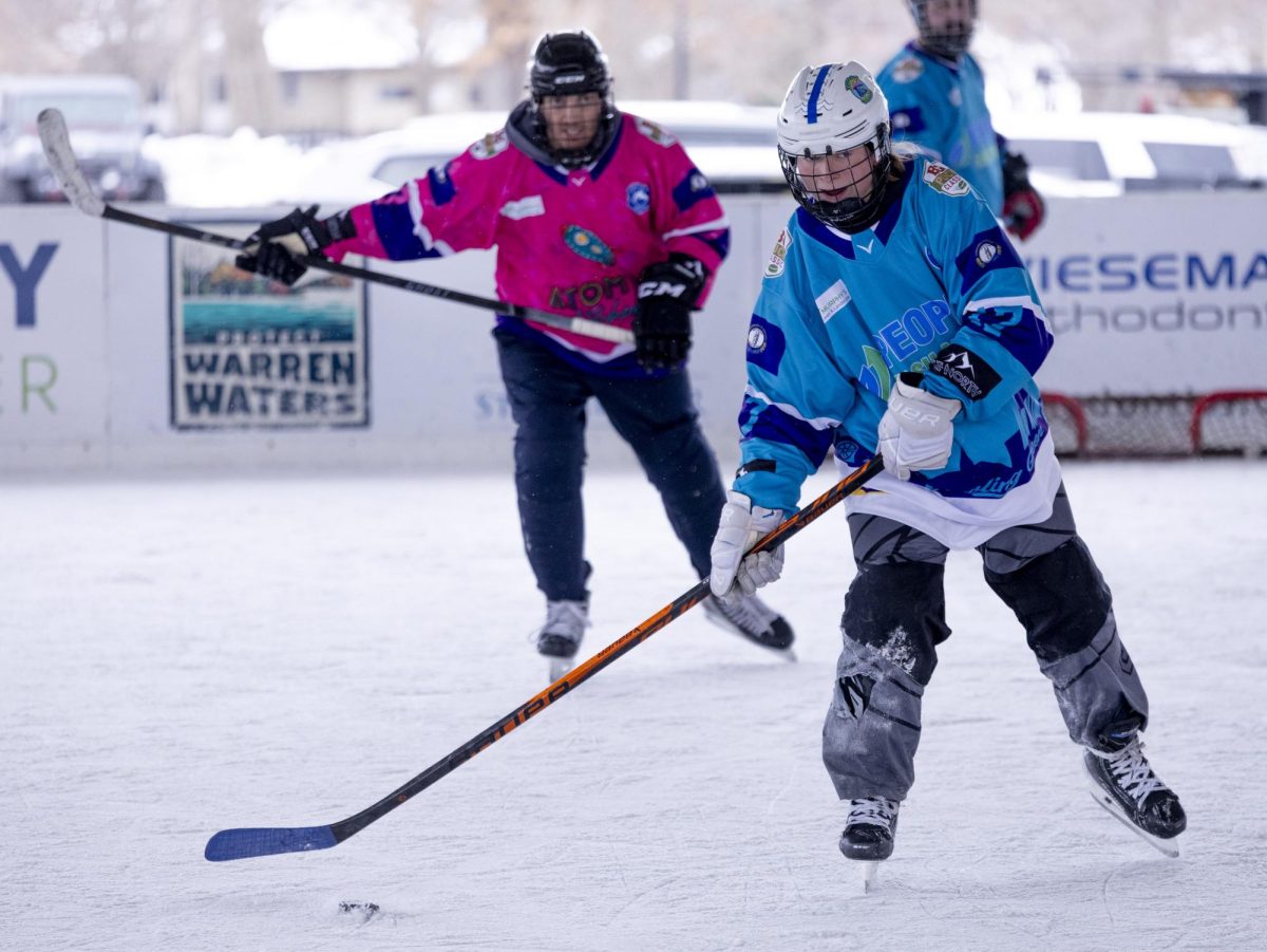 Team Peoples Cash (17) skates down the rink to make a shot on the goal during their game against Team Atomic on Friday, Jan. 30, 2026 during the third annual BG Puck Classic.