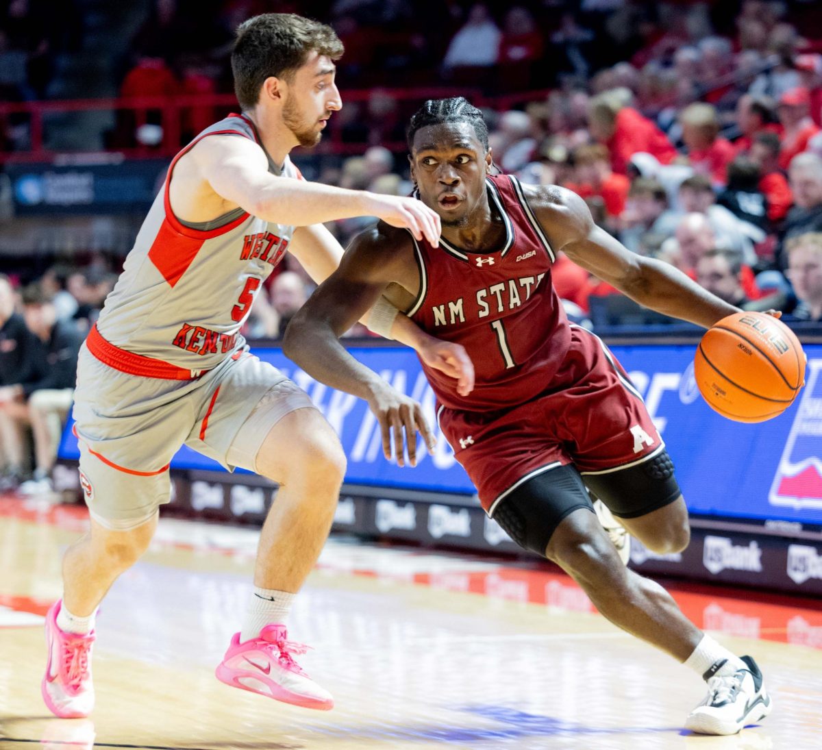 New Mexico State Aggies Guard Gabe Pickens (1) strides towards the goal as Western Kentucky Hilltoppers Guard Jack Edelen (5) guards him during WKU’s game at E.A. Diddle Arena Thursday February 26, 2026. 