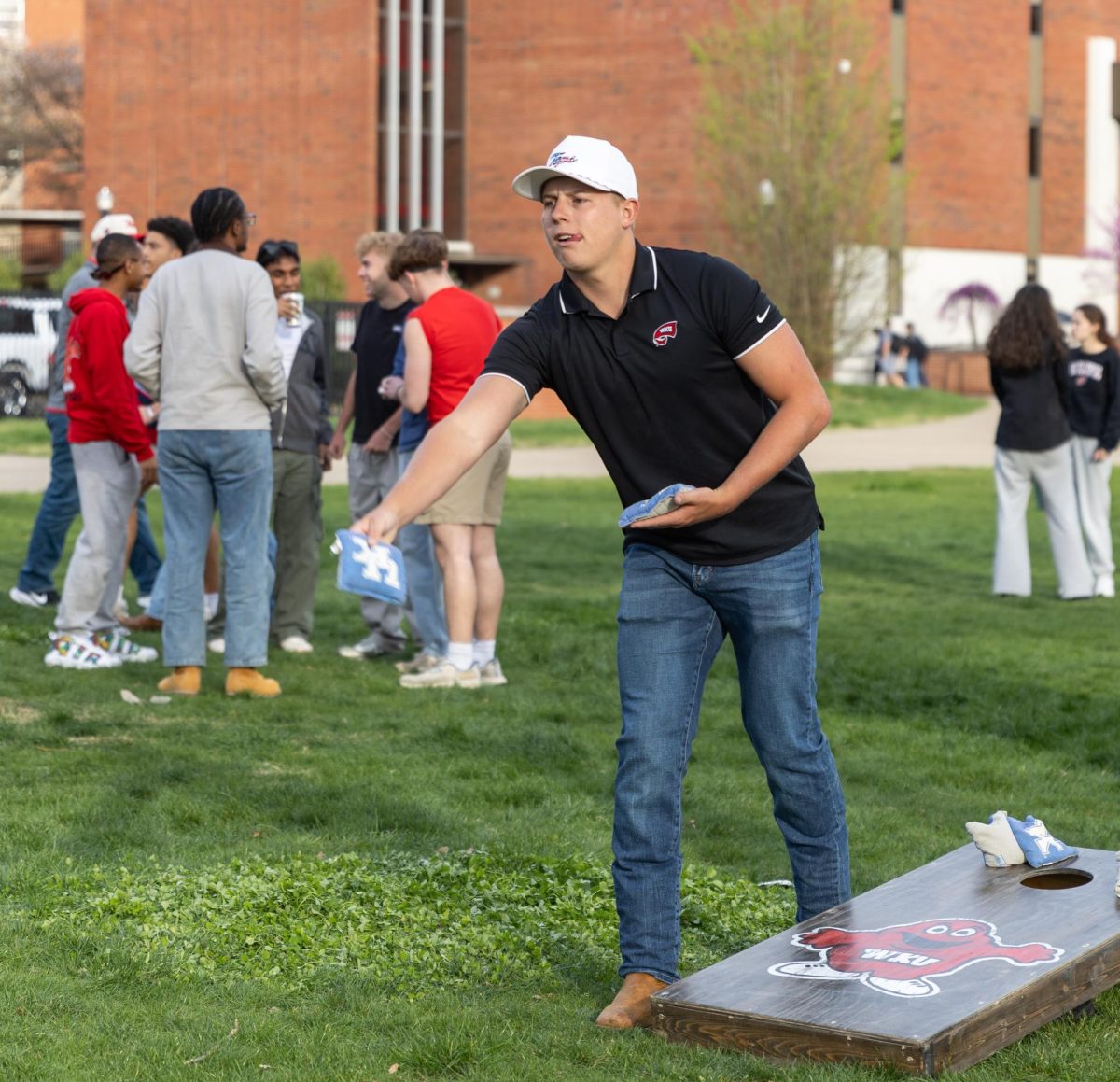 Trey Ward, a member of the Phi Gamma Delta fraternity at WKU. Participates in a game of corn hole on South Lawn before WKU’s baseball game against Louisville, on Tuesday, March 24, 2026.