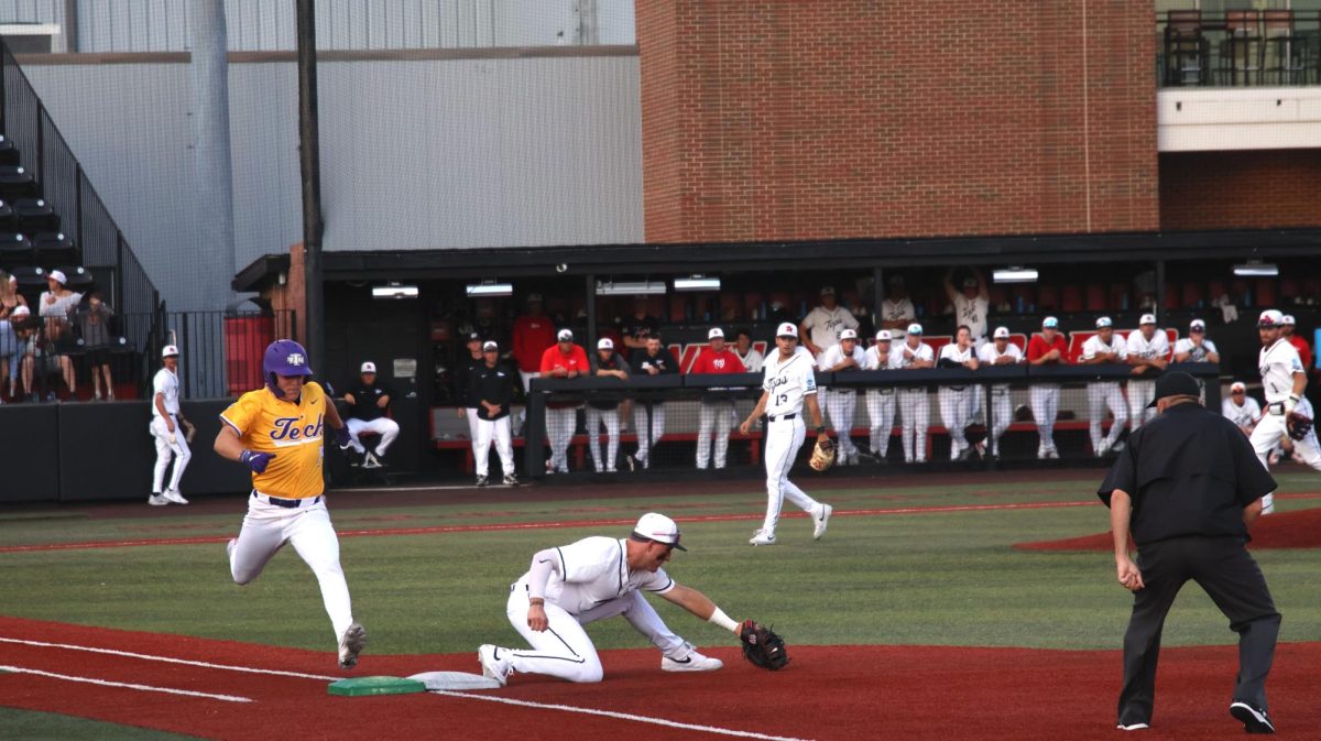 Fifth-year senior first baseman Kyle Hayes (20) picks a ball at first base as Tennessee Tech freshman outfield Landon Smelser (19) attempts to run out the throw during Western Kentucky University’s game against Tennessee Tech on Tuesday, March 31, 2026. 