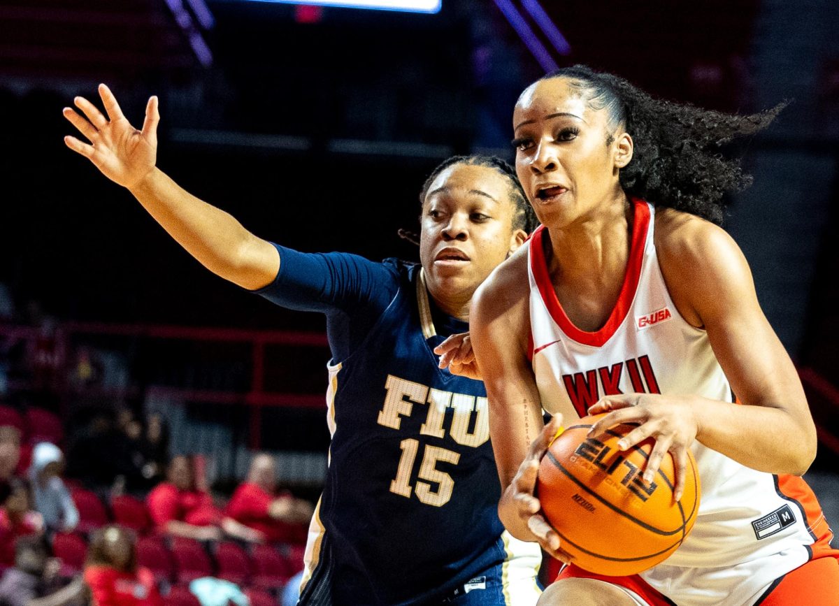 Western Kentucky University guard Trinity Rowe (11) attempts to cut past a Florida International University defender during WKU's game against FIU in E.A. Diddle Arena on Saturday, March 7, 2026.