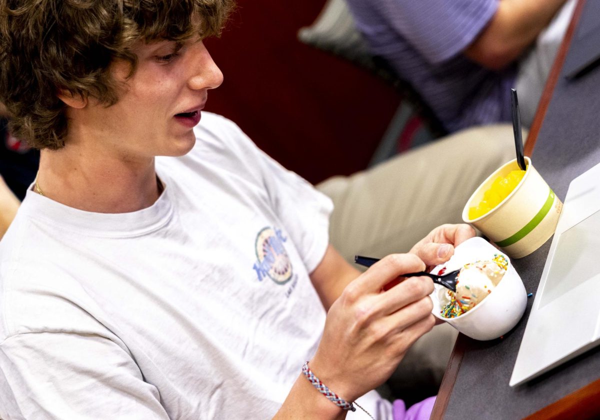 Senator Simon Petruska enjoys ice cream he got from Fresh Food Company prior to the SGA meeting in Senate Chambers on Thursday, April 2, 2026. Fresh had a special promotion where ice cream was served in baseball hat-themed cups. 