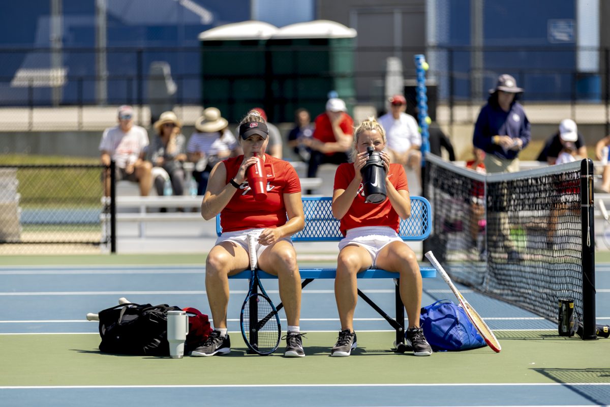 Western senior Elizabeth Sobieski (left) and freshman Isabelle EIness (right) take a water break in between sets of Western’s match against Middle Tennessee State University at the Warren County Tennis Facility at Michael O. Buchanon Park on Thursday, April 9, 2026.