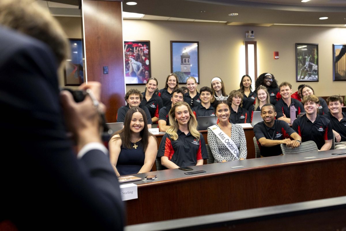 Chief Communications Officer Preston Jenkins takes a group photo of SGA members after junior nursing and healthcare administration major Chloe Ralston, a former SGA members, returned as a student speaker during the weekly meeting on Tuesday, April 14, 2026 in Senate Chambers. 