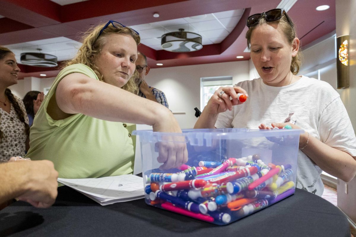 Participants grab bingo boards and markers to begin Singo Night presented by WKU's history department on Friday, April 14, 2026.