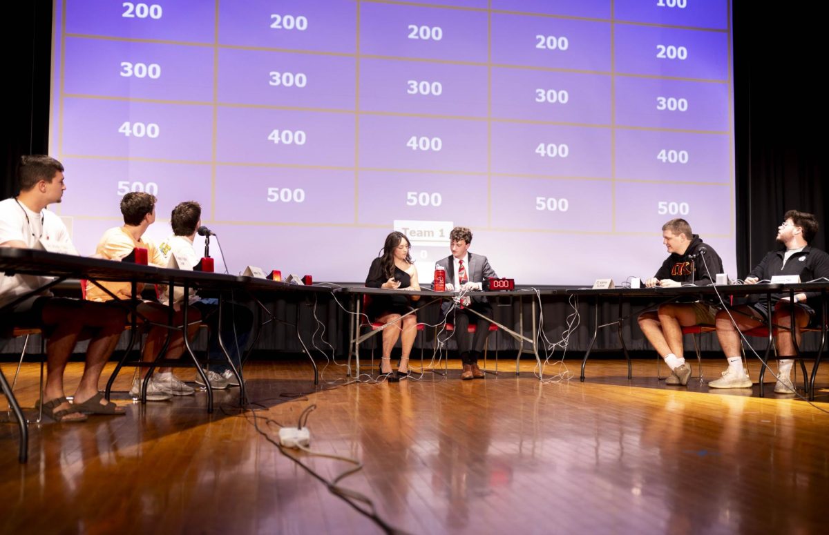 Fraternity members gather on stage to compete in Greek Jeopardy, held in celebration of Greek Week, on Tuesday, April 21, 2026 in Downing Student Union auditorium. 