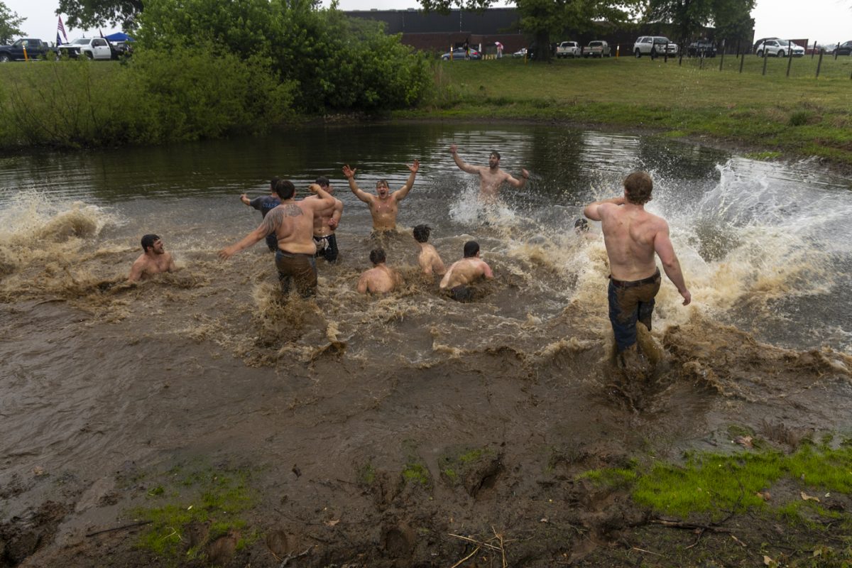 Phi Delta Theta’s tug team drives into a nearby pond following their victory against Alpha Gamma Rho in the finals of the annual Greek Week “Tug” competition at the WKU Agricultural Research and Education Center on Friday, April 24, 2026.