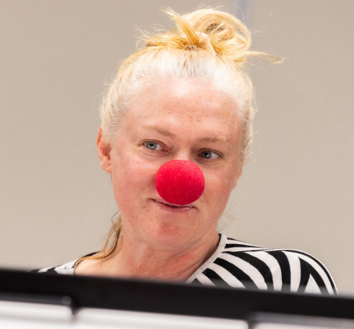 Shannon Swift (51) looks in a mirror after putting on a clown nose during the April Fools’ Clowning Hour at the Warren County Public Library Bob Kirby Branch in Bowling Green, Kentucky, on Wednesday, April 1, 2026. Swift said, “I didn’t tell anyone, but actually I’ve been a clown before. I did the clowning class and I became Sunny, and I was going to become a clown, but then I realized they were unpopular these days, and everyone was scared of clowns.”