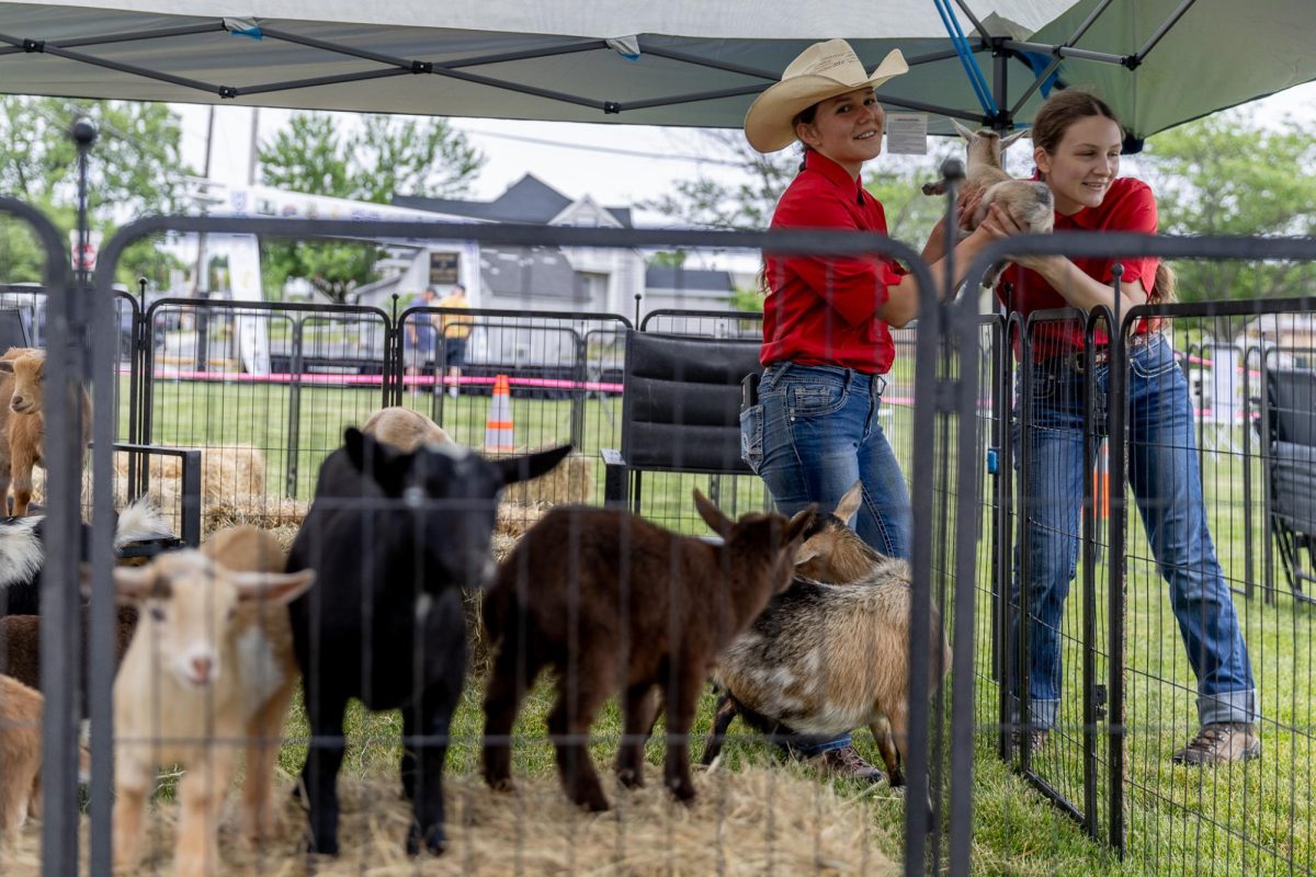 Sisters Rachel and Rebecca Smith pass along one of their baby goats from Little Red Barn Goats for an individual to hold during the Big Local Fest at Circus Square Park in Bowling Green, Ky., on Saturday, April 18, 2026.