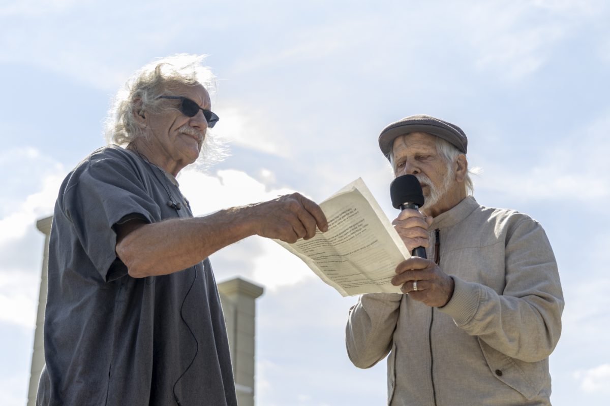 Tim Decker (left) and Micheal Gramling (right) use a microphone to bring awareness to their cause during Indivisible’s “May Day” protest for International Workers’ Day on the corner of Campbell Lane and Gary Farms Boulevard on Friday, May 1, 2026.