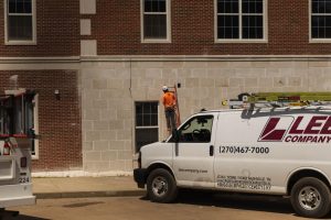 Construction worker repairs outer facade on Normal hall on May 13, 2026. 