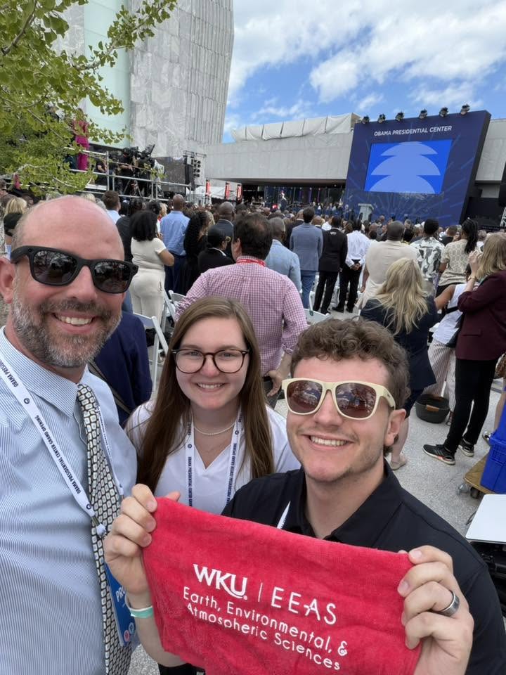 WKU meteorology professor Josh Durkee and his two Homeland Security Science master's students Harmoney Guercio and Thomas Payette pose with a WKU towel in front of the Obama Presidential Center Grand Opening Ceremony on June 18. Photo taken with permission from Durkee's Facebook.