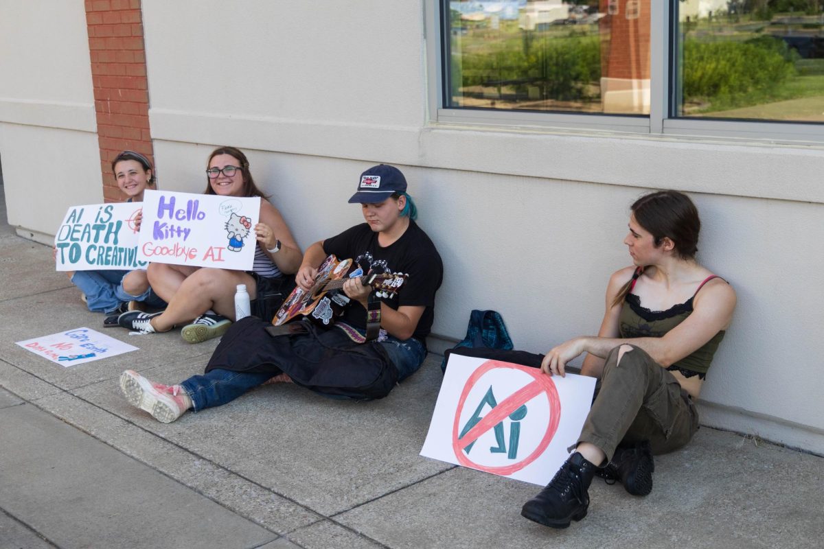 Kendall Hughey, Emily Victoriano, Salem Hollow and Jackie Wyman play music and protest artificial intelligence outside the Knicely Conference Center during the informational event on June 22, 2026.