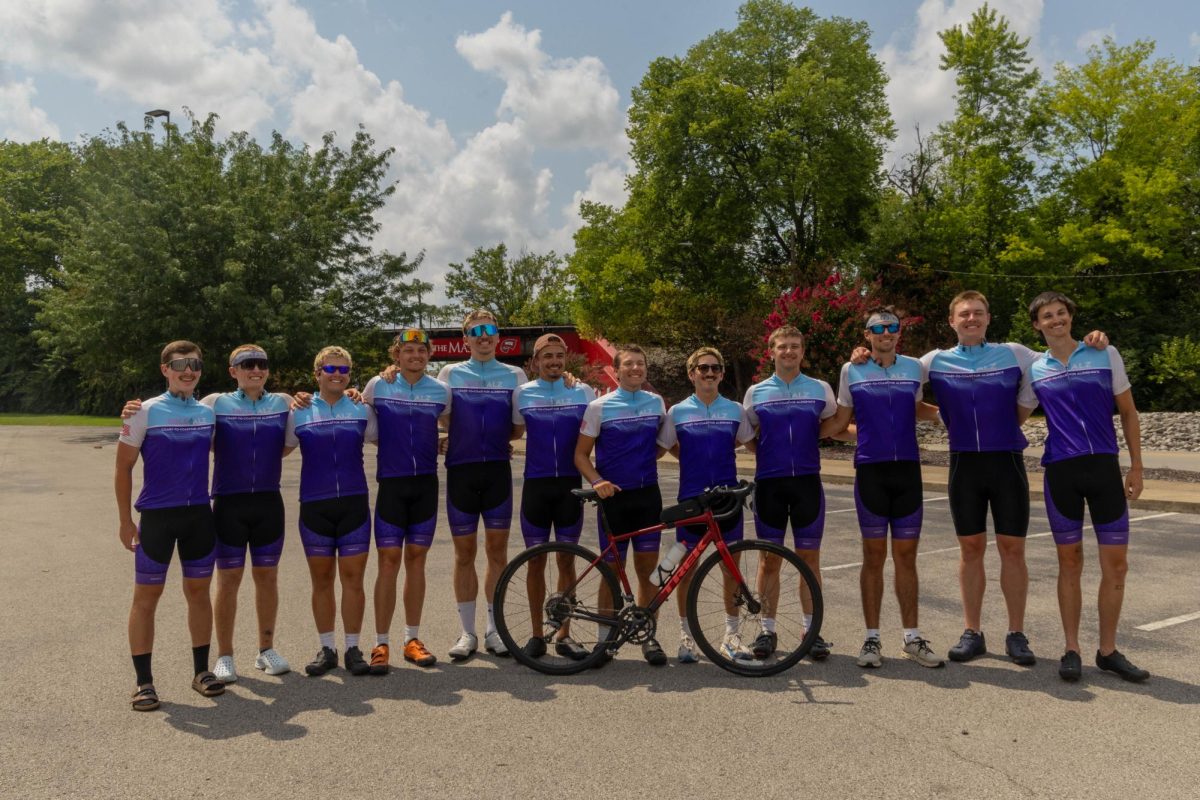 All 12 members of the Bike4Alz team pose for a picture with a bicycle upon arrival to Bowling Green on July 5.
